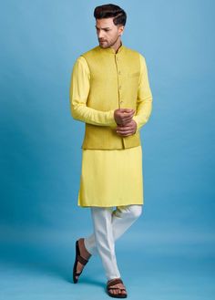 Editor's Note Yellow Nehru Jacket In Linen Base With Gota And Thread Embroidery. It Is Paired With A Matching Kurta And Contrasting Pyjama Pants. Color: Yellow Fabric: Linen Care: Dry Clean Only About the Designer Inspired By The Minimalism, Utilitarianism And Functionality, Chatenya Mittal Is A Label Focused Entirely On Menswear. Chatenya Mittal Is Revisiting The Classic Silhouette Bringing New Energy And Working To Create Future Classics By Subtly Combining Fabric Blocking, Layering, Attention Festive Designer Nehru Jacket With Stand Collar, Eid Bandhgala With Chikankari Embroidery And Stand Collar, Bandhgala With Chikankari Embroidery For Eid, Embroidered Sleeve Nehru Jacket For Eid, Nehru Jacket With Embroidered Sleeves For Eid, Traditional Long Sleeve Outerwear With Cutdana, Long Sleeve Nehru Jacket With Embroidered Sleeves For Eid, Eid Nehru Jacket With Embroidered Sleeves, Festive Designer Nehru Jacket With Front Open