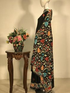 A Marvellous Embroidered Kashmiri Saree which you can wear at any party or a wedding.- - - - - - - - - - - - - - - - - - - - Product Details- Condition: Brand New (made to order)- Style: Saree Dress- Embroidery: All-over Kashmiri Aari Embroidery.- Base Colour: Black- Embroidery Colour: Multi-colour- Care Instructions: Dry Clean OnlyF A B R I CSaree: Viscose GeorgetteBlouse: Indian CrepeF I N I S H- UnstitchedYou can get it stitched locally.- StitchedWant your blouse ready to wear, let us know th Kashmiri Saree, Bridesmaid Shawl, Dress Traditional, Traditional Outfit, Aari Embroidery, Georgette Blouse, Dress Embroidery, Saree Indian, Black Embroidery