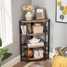 a corner shelf with books, magazines and vases on it in a living room