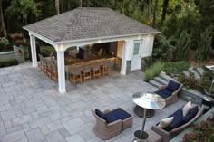 an outdoor living area with patio furniture and bar in the back yard is shown from above