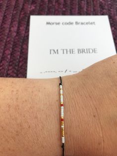 I'M The BRIDE Morse code bracelet (1 pc.) with hidden message. MORSE CODE bracelet will always be a special gift with special message and a great reminder of a special day, special occasion! Bracelet is made from: ☉ Thin nylon thread your choosen color, one size length 30 cm, 12 inches ☉ Small Japanesse beads Miuyki Delica. ☉ dash - silver and gold, dot - glass beads, spacer between words - any bead closest to thread color. ☉ Closure - Sliding bead or sliding knot. By shipping, all the bracelets Long Distance Relationship Bracelets, Bracelet Morse Code, Bracelet Morse, Morse Code Jewelry, Relationship Bracelets, Jewelry Bride, Couples Bracelet, Gold Dot, Gift Bracelet