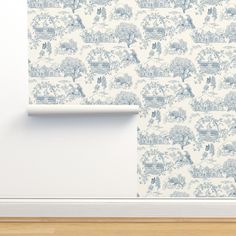 a wallpaper with blue toilers and trees on it in an empty room