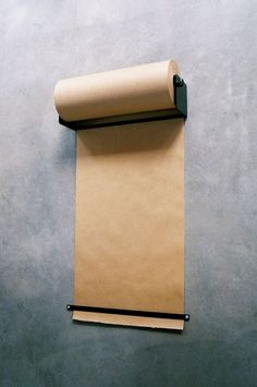 a roll of brown paper hanging on the wall