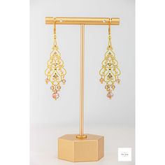 These unbelievably pretty and fashionable Amber glass filigree dangle earrings are a stunning addition to any jewelry collection. The shimmering, faceted amber glass beads are perfectly paired with the lovely gold-plated filigree and lever backs for a lightweight, secure fit and luxurious look. Beautiful, Amber and white colored faceted glass beads. Gold-plated filigree. Gold-plated wire and lever backs. 2.75 inches long. These earrings are perfect for a night out or a special event and make a m Elegant Rose Gold Earrings With Dangling Beads, Gold Crystal Earrings With Dangling Beads For Wedding, Elegant Gold Wire-wrapped Crystal Earrings, Elegant Gold Crystal Earrings Wire Wrapped, Elegant Gold Wire Wrapped Crystal Earrings, Gold Wire Wrapped Crystal Earrings For Wedding, Elegant Gold Crystal Earrings With Dangling Beads, Elegant Gold Wire Wrapped Beaded Earrings, Gold Beaded Chandelier Earrings For Gift