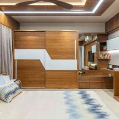 a bedroom with wood paneling and white bedding