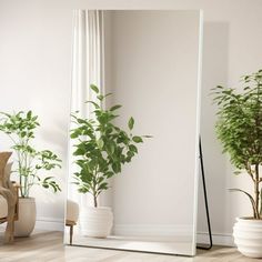 a large mirror sitting on top of a wooden floor next to a chair and potted plant