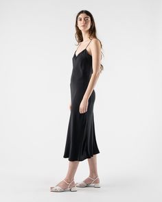 Loretta Midi Slip Dress in Black from Kamperett. Silk mid-calf slip dress with spaghetti straps. Featuring a straight cut neckline and a V at the back. Designed to be layered under the Meiere Midi Dress. 100% Silk Charmeuse Matte side out Sustainably and ethically made in California Sam is 5'8 and wearing size small Size Bust Waist Hip Length XS 30" 28" 42" 46" S 32" 30" 44" 46" M 34" 32" 46" 46" L 36" 34" 50" 46" XL 38" 36" 52" 47" 1X 40" 38" 54" 47" Kamperett Kamperett is a womenswear line fro Elegant Midi Slip Dress With Adjustable Straps, Evening Midi Dress With Spaghetti Straps, Sleek Spaghetti Strap Midi Dress For Formal Occasions, Chic Spaghetti Strap Cocktail Slip Dress, Sleek Formal Midi Dress With Spaghetti Straps, Chic Slip Dress With Spaghetti Straps For Cocktails, Evening Midi Slip Dress With Adjustable Straps, Silk Slip Dress With Spaghetti Straps For Cocktail, Formal Sleeveless Slip Dress With Adjustable Straps