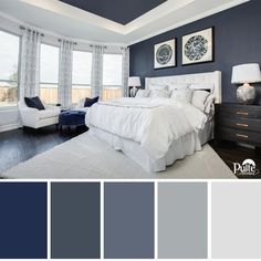 a bedroom with dark blue walls and white bedding, gray curtains, black dressers