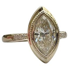 a yellow gold ring with a pear shaped diamond