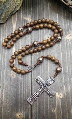 Wood Rosary Beads Necklace Catholic wooden rosary necklace with Our Father Cross and Madonna medal. Cross (H X W) : 7 cm x 3.5 cm / 2.8" x 1.4" Rosary Length: 49 cm / 19", Nazareth Store Customized Gift Velvet Bag Religious rosary of Nazareth Store makes a wonderful gift for any occasion, birthday, confirmation, First Communion, Baptism, Mother day, Christening & ideal gift for Catholic and Orthodox Christians. packed in a velvet bag to provide extra protection. Bronze Rosary With Round Beads As Gift, Bronze Rosary As Gift, Antique Jewelry With 8mm Beads As Gift, Antique Jewelry With 8mm Beads For Gift, Antique 8mm Beads Jewelry As Gift, Vintage Cross Necklaces With 8mm Beads, Vintage Cross Necklace With 8mm Beads, Vintage Bronze Rosary As Gift, Vintage Cross Jewelry With 8mm Beads