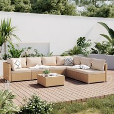 an outdoor living area with couches, tables and potted plants on the deck