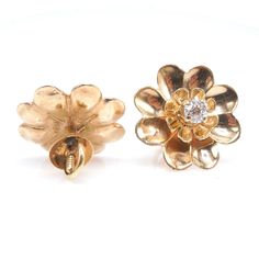 "These charming vintage earrings, in the shape of a daisy, are made of 14K yellow gold and have a diamond prong set in their center. Perfect for \"setting and forgetting,\" these earrings are secured with a screw back, meaning you'll never have to worry about one of them falling out! DETAILS METAL: 14K Yellow Gold DIAMONDS: 2x European Cut diamonds (0.40tcw) WIDTH: 17mm" 14k Yellow Gold Flower Earrings For Anniversary, Gold Flower Earrings With Brilliant Cut, Yellow Gold Flower Cluster Earrings For Anniversary, Formal Yellow Gold Cluster Earrings In Flower Shape, Gold Flower Diamond Earrings With Prong Setting, Yellow Gold Flower Earrings With Prong Setting, Classic Yellow Gold Flower-shaped Cluster Earrings, Yellow Gold Flower Earrings With Brilliant Cut, Classic Flower Shaped Diamond Earrings For Formal Occasions