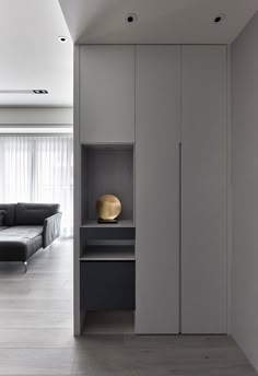 a modern living room with white walls and wood flooring on the other side of the room