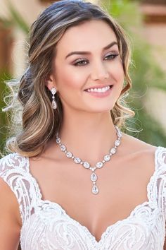 a woman wearing a wedding dress and jewelry