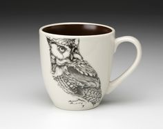 a coffee cup with an owl drawn on it