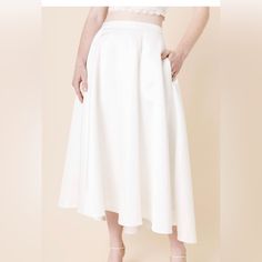 - Length 32" / Waist 28" - Measured From A Size S. - 100% Polyester - Hand Wash Cold Water; Lay Flat To Dry. - Non-Stretch - Models Are Approximately 5’10” And Wear A Size Small You'll Feel Romantic And Effortlessly Stylish In This Side Pocket Wedding Skirt. This High-Low Skirt Looks Amazing With A Lace Tank Top As The Perfect Bridal Outfit For Your Special Events. Spring Wedding A-line Skirt, White Lined Skirt Bottoms For Evening, White Lined Skirt For Evening, White A-line Formal Bottoms, Chic A-line Wedding Skirt, White Lined Skirt For Formal Occasions, White Lined Formal Skirt, White Flared Evening Skirt, White Long Party Skirt