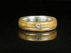 a wooden ring with a diamond in the center