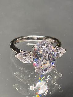 an oval cut diamond ring with three pear shaped diamonds