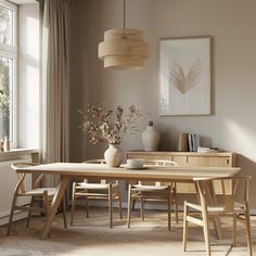 a dining room table and chairs in front of a window with an art work on the wall