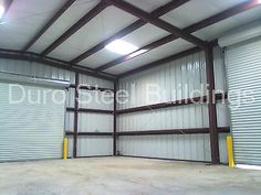 an empty garage with roller up doors