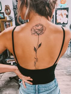 a woman with a flower tattoo on her back