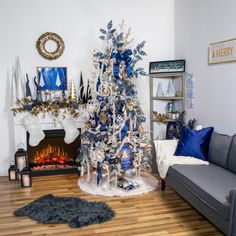 a living room with a christmas tree in the corner and a couch next to it