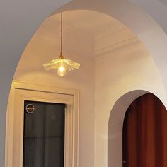 an arched doorway with a light hanging from the ceiling