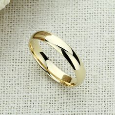 Elegant Harmony ✨💎 It gives you beautiful, attractive and outstanding jewelry experience ✨ Everlasting Confidence Wonderful Quality Stay Shiny Exquisite Fit 15,000+ customer reviews Free Shipping & Returns *Learn more 👍 Recommendations Perfect for everyday wear Ideal for travel or a destination wedding A perfect choice for an anniversary gift Description: This elegant wedding band is crafted from solid 14K gold and features a high-polished plain dome design that exudes timeless sophistication. Classic 14k Gold Wedding Jewelry, Classic Yellow Gold Jewelry For Weddings, Gold Wedding Jewelry With Classic Design, Gold Jewelry With Shiny Finish For Wedding, Classic Round Band Jewelry For Marriage, Simple Round Cut Wedding Jewelry, Round Polished Wedding Jewelry, Round Polished Finish Jewelry For Wedding, Classic Jewelry With Polished Finish For Marriage