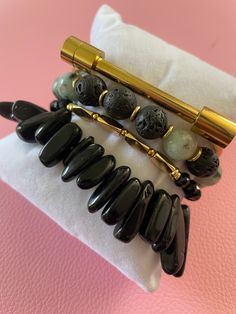 Gemstone Significance: Black Obsidian: Known for its grounding and protective properties, black obsidian helps to shield against negativity and promote emotional balance. Dalmatian Jasper: This unique stone is believed to bring a sense of playfulness and joy, encouraging a positive outlook and a sense of harmony. Versatile Style: The Obsidian & Jasper Bracelet Set is perfect for adding a touch of elegance and sophistication to any outfit. Whether you're dressing up for a special event, adding flair to your everyday look, or seeking a meaningful gift, these bracelets are a versatile and stylish choice. Description: Enhance your jewelry collection with the Obsidian & Jasper Bracelet Set. Handcrafted by skilled artisans, this set features four stunning bracelets made with black obsidian and d Black Spiritual Beaded Bracelets As Gift, Spiritual Black Beaded Bracelets As Gift, Black Onyx Jewelry For Meditation, Modern Black Hand-strung Bracelets, Modern Black Hand-strung Bracelet, Elegant Obsidian Bracelets For Meditation, Minimalist Black Bracelet For Meditation, Minimalist Black Bracelets For Meditation, Modern Onyx Bracelets For Gift