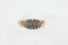 Beautiful Victorian Ring. Oval top with Turquoise and Pearl seed bezel set into a 10k Flower ornate shank.  Absolutely stunning. Condition: Shows some signs of use. Consistent with age. Made beginning of century. Details: 2.5mm turquoise 1.2mm pearl seeds Sz6.75 1.6grams Unmarked tests 10k Victorian Turquoise Jewelry For Wedding, Victorian Turquoise Jewelry For Anniversary, Turquoise Victorian Jewelry For Anniversary, Antique Turquoise Round Ring For Wedding, Antique Turquoise Ring For Wedding, Antique Round Turquoise Wedding Ring, Wedding 14k Gold Turquoise Cabochon Ring, Antique Turquoise Cabochon Ring For Wedding, Antique Style Turquoise Wedding Ring With Cabochon