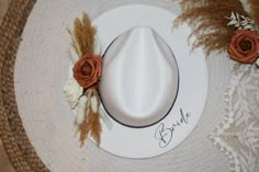 "CURRENTLY ONLY BROWN BAND AVAILABLE  NEW FLOWER COLORS AVAILABLE! 🤍 VEIW OTHER LISTING TO CHANGE HAT COLOR  🤍 Every Bride needs this hat! It's perfect for bridal events including dress shopping, bridal shower, bachelorette, and even your honeymoon! It is boho, fashionable, and unique! 🤍 -adjustable hat -one size fits most people! -breathable, lightweight and comfortable -Material: 65% Cotton, 35% Polyester  -Size:      Hat circumference: 56-58cm/22.22.8\"      Brim width: 7cm/2.75\"     Heig Adjustable Fedora Straw Hat For Wedding, Bohemian Wedding Hat With Adjustable Fit, Bohemian Adjustable Wedding Hat, Custom Adjustable Wedding Hats, Handmade Wedding Hat With Curved Brim, Handmade Curved Brim Hat For Wedding, Adjustable Fedora Mini Hats For Wedding, Handmade White Wedding Hat, Adjustable Short Brim Felt Hat For Wedding