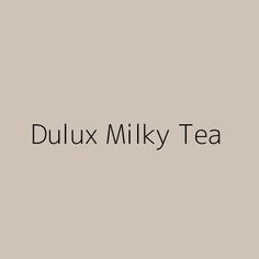 the words dulux milky tea are in black and white