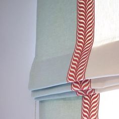 the blinds are closed with red and white designs on them