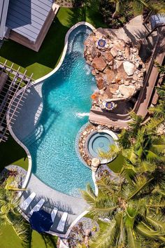 an aerial view of a swimming pool surrounded by palm trees