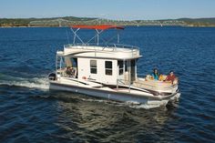 people are riding on the back of a house boat