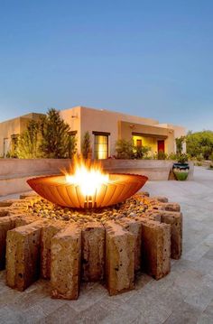 an outdoor fire pit with rocks around it