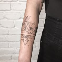 a woman with a flower tattoo on her arm