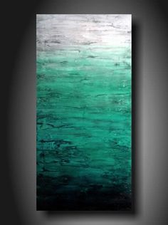 an abstract painting with green and white colors on the canvas, hanging in a dark room