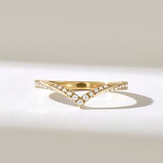 a yellow gold ring with three rows of diamonds