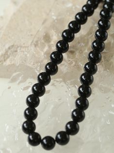 Experience the bold elegance of our "Handwoven Onyx Magnetic Clasp Necklace" – expertly crafted with black onyx stones and a handwoven design, secured by a magnetic clasp. Add a touch of sophistication and mystery to your look with the deep, velvety black stones, while the artisanal touch and convenience of the magnetic clasp make it a unique and effortless accessory. Metal: Recycled Sterling Silver Plated On Brass Gemstone: Black Onyx Necklace Length: 440mm Weight: 83g-88g Elegant Black Jewelry With 108 Beads, Black Single Strand Necklace, Formal Black Necklace With Gemstone Beads, Elegant Obsidian Jewelry With Polished Beads, Formal Black Obsidian Jewelry, Onyx Bead Necklaces With 8mm Round Beads, Onyx Bead Necklace With 8mm Round Beads, Onyx Necklace With 8mm Round Beads, Black Formal Necklace With Round Beads