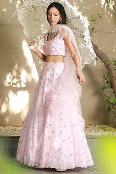 Blush Pink Net Embroidered Lehenga Set Featuring a blush pink lehenga in net base with cutdana and sequins hand embroidery. It is paired with a matching blouse, a cancan and a dupatta. This product will be shipped to you after 1-2 weeks from the date of order placed. All custom made orders are not returnable. Pls contact for Size chart and for other more colors Request You :To provide contact details for courier services. {VARIATION MAY COME DEPENDING UPON AVALIBILITY OF LACES OR GOTTA PATI} NOTE:  1) Visual Samples on website may differ slightly from actual product due to light & effects during photography (Length & Breadth have 1 n 1.5 inches  +/-). 2) Before placing order ,pls confirm product n color availability on +91 7903893945 & +91 8447750028(WhatsApp) 3) For Wholesale Order MOQ is Blush Pink Lehenga, Ruffle Dupatta, Berry Dress, Pink Lehenga, Krishna Janmashtami, Embroidered Lehenga, Pattern Embroidery, Ganesh Chaturthi, Pink Sequin