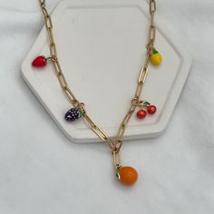 Get ready to add some deliciousness to your look with our Fruit Salad Charm Necklace! This fun accessory is adorned with vibrant enamel fruit charms that will give your outfit a burst of personality. Add some charm and quirkiness to your style with this playful necklace. 18kt gold plated enamel charms, featuring 5 charms (strawberry, blackberry, orange, cherry, and lemon) paperclip chain, links measure 12mmx4mm gold stainless steel for long-term worry-free wear with no tarnish Necklace Outfit, Enamel Charms, Accessories Earrings, Phone Charm, Initial Charm, Personalized Necklace, Paper Clip, Ring Bracelet, Initial Necklace