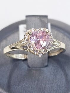 a pink heart shaped diamond ring on display