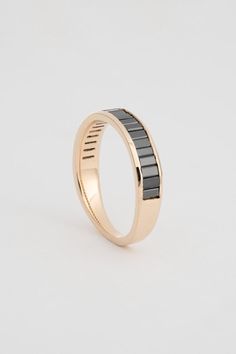 a gold ring with black stripes on it