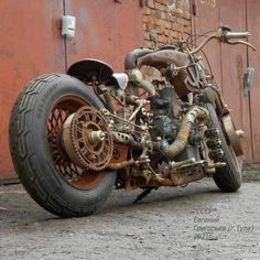 an old motorcycle is parked in front of a building