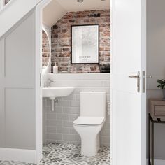 an open door leading to a bathroom with brick walls