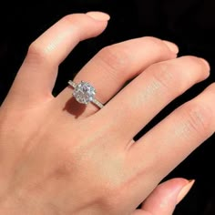 a woman's hand with a diamond ring on it