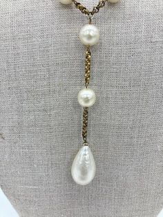 Vintage Chanel Pearl Lariat Necklace in very good condition. 1/2" pearl beads strung through a gold tone chain in a unique Y lariat style. 4.5" straight chain drop at center of Y with 1.25x.75" Teardrop pearl at end. Overall very good vintage condition. pearls are clean with no major scuffs or damage. Light tarnish on metal chain throughout. See photos for details. 39" total length end to end. Creator: Chanel Stone: Pearl Stone Cut: Bead Period: 1980-1989 Date of Manufacture: 1980s Condition: Good Pearl Lariat Necklace, Chanel Pearl, Pearl Lariat, Chanel Pearls, Pearl Stone, Gold Ounce, Vintage Pearls, Bead Stringing, Necklace Vintage