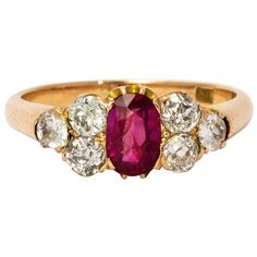 A beautiful late Victorian ring, centrally set with a stunning ruby measuring approximately 65 points and with great pink colour. Either side sits a trio of old European cut diamonds measuring a total of 90 points. Total diamond weight 1.8 carats. Modelled in 18 karat yellow gold. Ring Size: O or 7.5 Victorian Ring, Buckle Ring, Yellow Gold Diamond Ring, Victorian Rings, Diamond Ring Settings, European Cut Diamonds, Pink Colour, Domed Ring, Pear Shaped Diamond