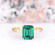 Exquisite Green Emerald Ring, a dazzling testament to love and timeless elegance. Crafted with meticulous attention to detail, this set features a stunning Emerald Cut emerald gemstone cradled in a setting of lustrous 14K yellow gold vermeil, creating a truly captivating piece of jewelry. ►The centerpiece of this ring set is the magnificent emerald, the birthstone of May, renowned for its rich green hue symbolizing renewal and growth. Its unique shape adds a contemporary twist to a classic gemst Classic Gold Emerald Wedding Ring, Classic May Birthstone Ring With Accent Stones, Fine Jewelry Emerald Ring With Accent Stones For Promise, Fine Jewelry Emerald Ring With Accent Stones, Fine Jewelry Emerald Ring With Cubic Zirconia, Elegant Cubic Zirconia Rings For May Birthstone, Elegant Emerald Ring With Center Stone For Gift, Dazzling Emerald Ring With Center Stone For Anniversary, Elegant Rings With May Birthstone Gemstone